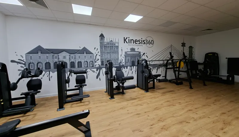 Wandbild in Grautönen im Trainingsraum einer Praxis: Stadtsilhouette mit historischen Gebäuden, Brücke und Farbspritzern über Trainingsgeräten